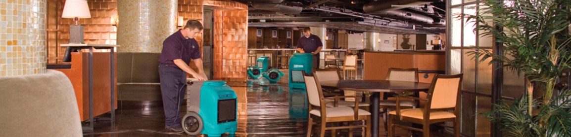 two tech cleaning up a flooded space
